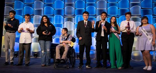 Some of the 2023 Yes I Can awardees standing on the CEC 2023 Convention stage with their awards.